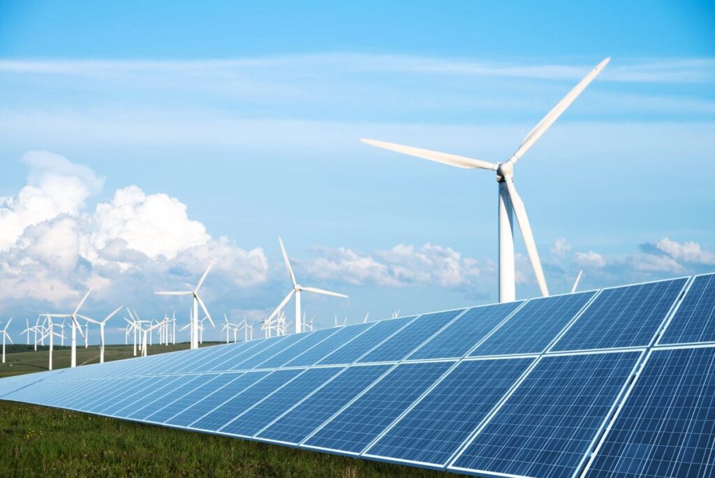 solar panel in green lawn with wind power station